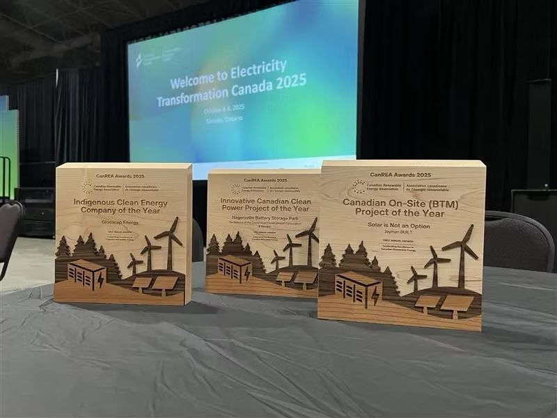 Three Canadian Renewable Energy Association awards on a table